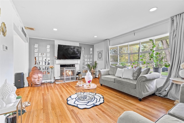 63 Wright Blvd, Hopewell Junction, NY 12533 - living room featuring ornamental molding, wood finished floors, a fireplace, and recessed lighting
