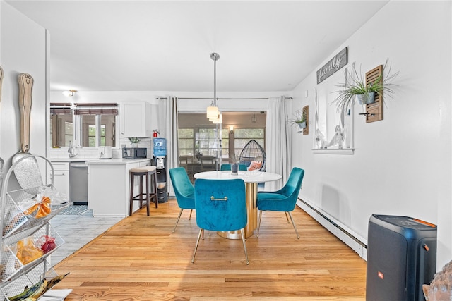 63 Wright Blvd, Hopewell Junction, NY 12533 - dining space featuring light wood-style floors, a baseboard heating unit, and healthy amount of natural light