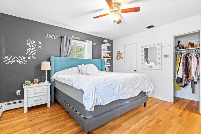 63 Wright Blvd, Hopewell Junction, NY 12533 - bedroom featuring light wood-style flooring, a baseboard heating unit, ceiling fan, and a closet