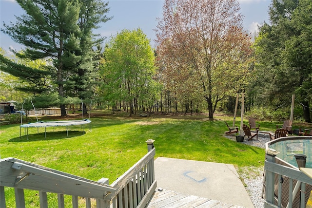 63 Wright Blvd, Hopewell Junction, NY 12533 - view of grassy yard with a trampoline and a wooden deck