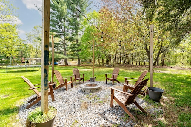 63 Wright Blvd, Hopewell Junction, NY 12533 - view of grassy yard featuring an outdoor fire pit and a trampoline