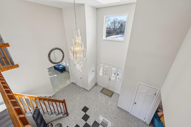 1 Deforest Ct, West Nyack, NY 10994 - entrance foyer with a chandelier, a high ceiling, carpet flooring, a skylight, and stairs