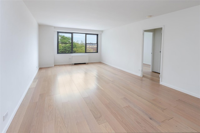 2500 Johnson Ave Unit 3B, Bronx, NY 10463 - spare room featuring light wood-style flooring, a smoke detector, baseboards, and radiator