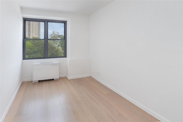 2500 Johnson Ave Unit 3B, Bronx, NY 10463 - spare room featuring radiator heating unit, light wood-type flooring, and baseboards