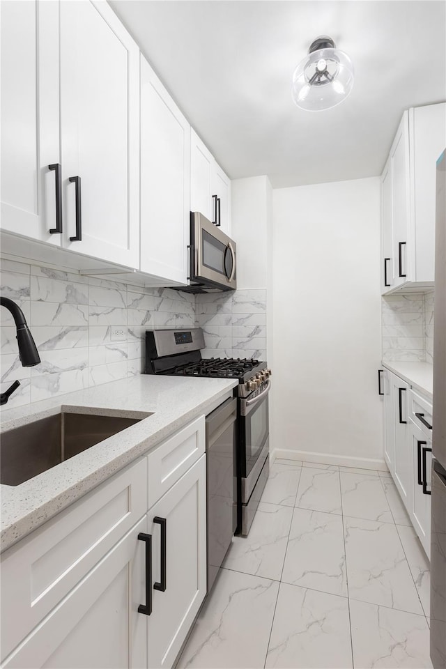 2500 Johnson Ave Unit 3B, Bronx, NY 10463 - kitchen with appliances with stainless steel finishes, a sink, light marble finish flooring, and light stone counters