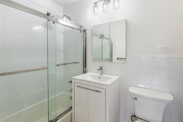 2500 Johnson Ave Unit 3B, Bronx, NY 10463 - bathroom with bath / shower combo with glass door, toilet, vanity, and tile walls