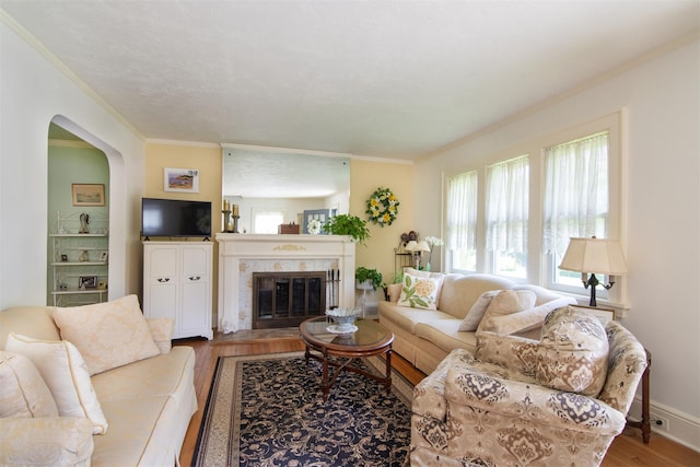 238 Read Ave, Tuckahoe, NY 10707 - living room with wood finished floors, crown molding, arched walkways, and a tile fireplace