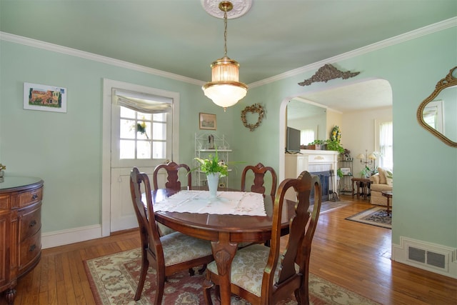 238 Read Ave, Tuckahoe, NY 10707 - dining room featuring arched walkways, healthy amount of natural light, crown molding, hardwood / wood-style flooring, and baseboards