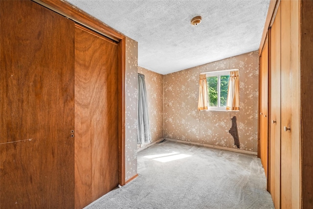 1 Battery Pl, Croton-On-Hudson, NY 10520 - unfurnished bedroom featuring wallpapered walls, carpet floors, a textured ceiling, and a closet