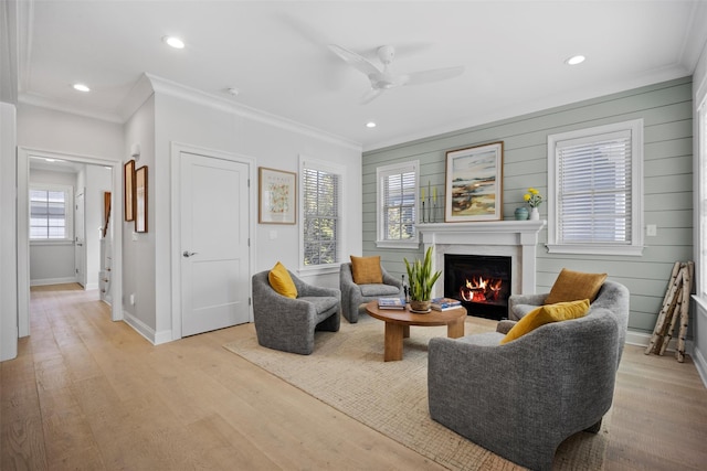 6 Livingston St, Red Hook, NY 12571 - living area featuring crown molding, a warm lit fireplace, a ceiling fan, baseboards, and light wood finished floors