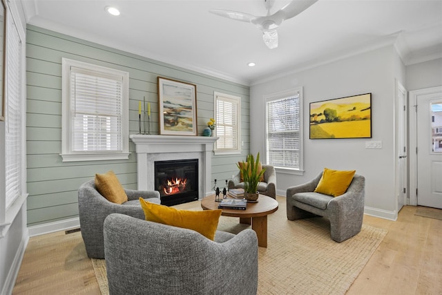 6 Livingston St, Red Hook, NY 12571 - living area featuring crown molding, a glass covered fireplace, ceiling fan, light wood-type flooring, and baseboards