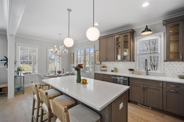6 Livingston St, Red Hook, NY 12571 - kitchen featuring a sink, ornamental molding, a breakfast bar area, tasteful backsplash, and light countertops