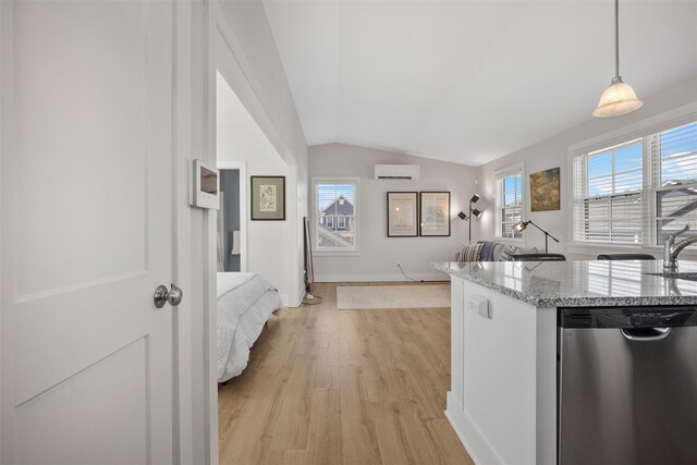 6 Livingston St, Red Hook, NY 12571 - kitchen featuring stainless steel dishwasher, lofted ceiling, light wood finished floors, light stone countertops, and decorative light fixtures