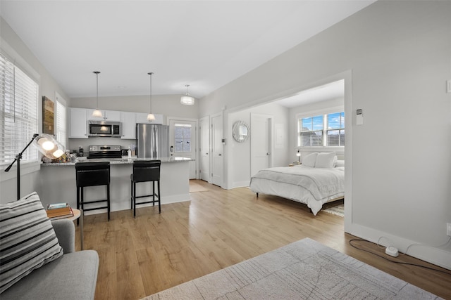 6 Livingston St, Red Hook, NY 12571 - bedroom with freestanding refrigerator, light wood-style floors, vaulted ceiling, and baseboards