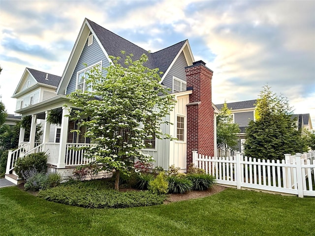6 Livingston St, Red Hook, NY 12571 - view of side of property with board and batten siding, a shingled roof, a chimney, and a porch