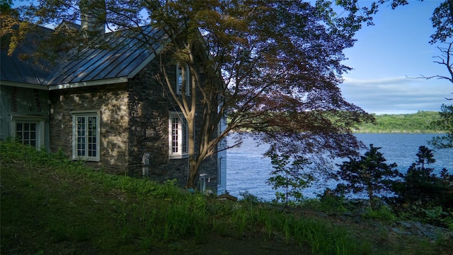 70 Floyd Ackert Rd, West Park, NY 12429 - view of side of home with stone siding, a standing seam roof, a water view, and metal roof