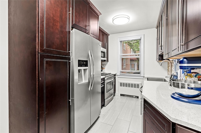 5 Bryant Cres Unit 1B, White Plains, NY 10605 - kitchen featuring radiator, stainless steel appliances, a sink, light stone counters, and light tile patterned flooring
