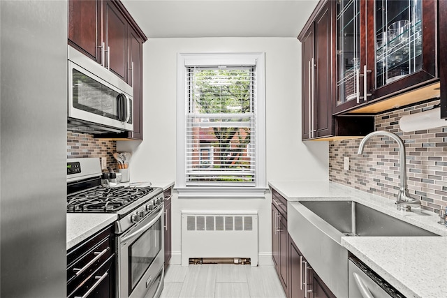 5 Bryant Cres Unit 1B, White Plains, NY 10605 - kitchen featuring stainless steel appliances, radiator heating unit, a sink, and backsplash