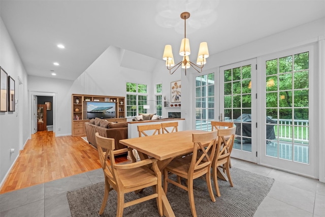 56 Londonderry Ln, Somers, NY 10589 - dining area featuring a fireplace, light tile patterned flooring, a chandelier, recessed lighting, and lofted ceiling