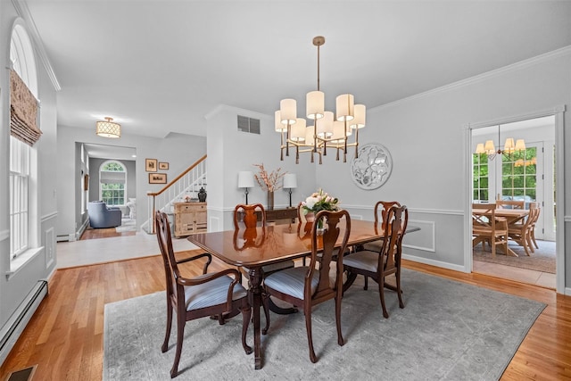 56 Londonderry Ln, Somers, NY 10589 - dining room with baseboard heating, a chandelier, stairs, light wood finished floors, and crown molding