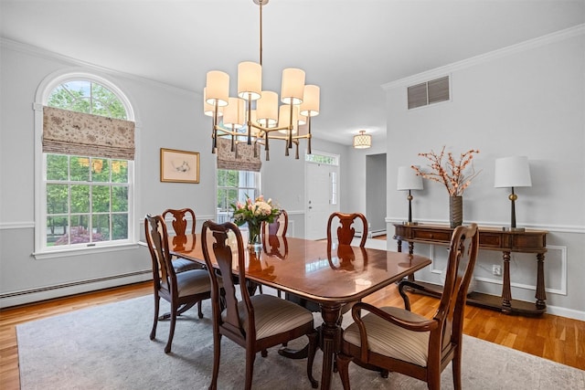 56 Londonderry Ln, Somers, NY 10589 - dining room featuring wood finished floors, ornamental molding, a baseboard heating unit, and a chandelier