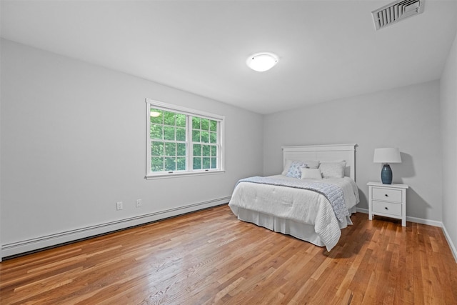 56 Londonderry Ln, Somers, NY 10589 - bedroom with a baseboard radiator, wood finished floors, and baseboards
