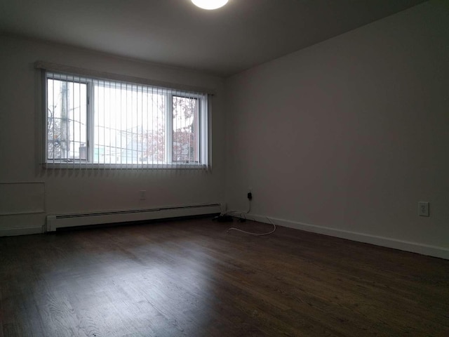 5465 Sylvan Ave, Bronx, NY 10471 - unfurnished room featuring baseboard heating, dark wood finished floors, and baseboards