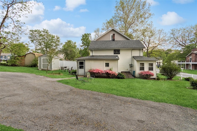35 Fallkill Ave, Poughkeepsie, NY 12601 - rear view of property with a shed, a shingled roof, an outdoor structure, and a lawn