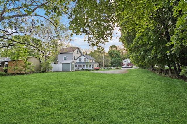 35 Fallkill Ave, Poughkeepsie, NY 12601 - view of grassy yard featuring a storage unit and an outbuilding