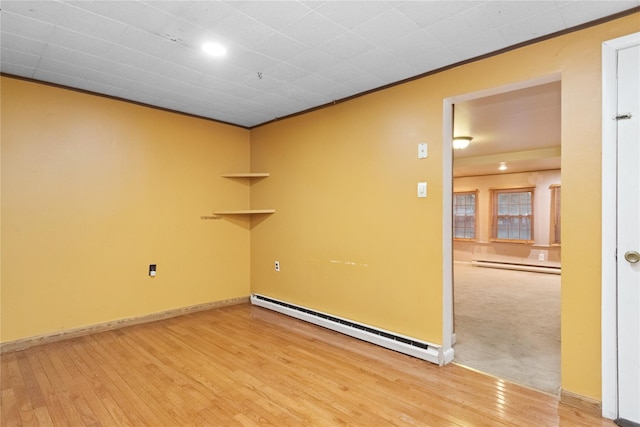 35 Fallkill Ave, Poughkeepsie, NY 12601 - empty room featuring a baseboard heating unit, wood finished floors, ornamental molding, and baseboards