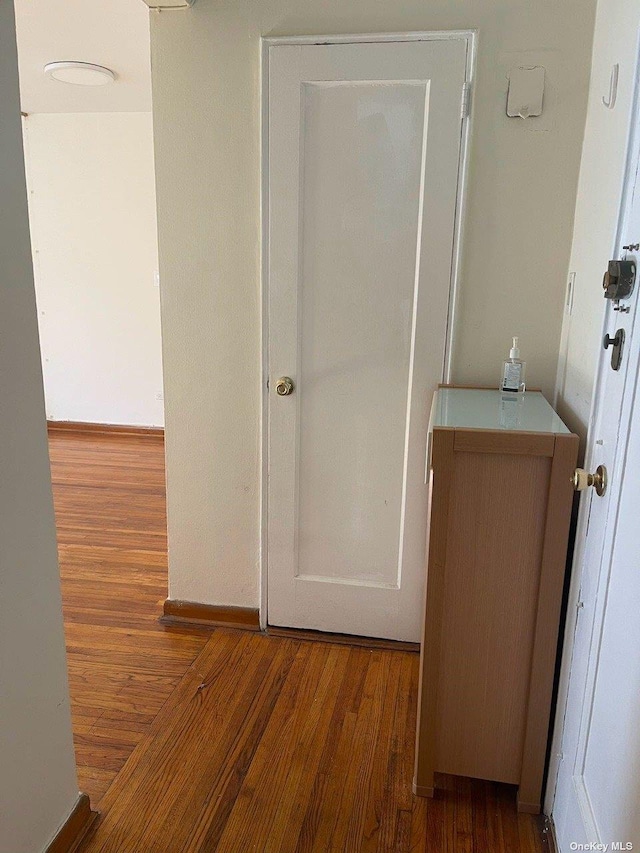 hall with wood finished floors
