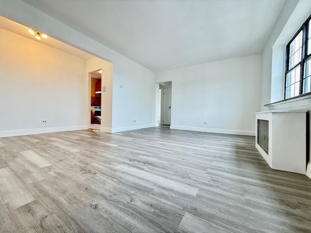 78-16 147th St # # 3C, Flushing, NY 11367 - unfurnished living room featuring a fireplace, wood finished floors, and baseboards