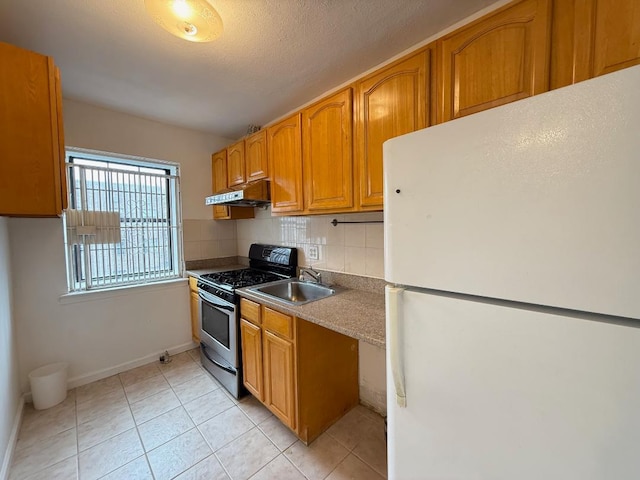 78-16 147th St # # 3C, Flushing, NY 11367 - kitchen featuring freestanding refrigerator, stainless steel gas range, under cabinet range hood, a sink, and backsplash