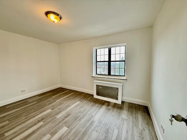 78-16 147th St # # 3C, Flushing, NY 11367 - unfurnished living room with wood finished floors, baseboards, and radiator
