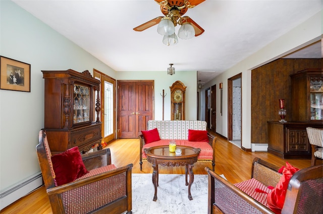 68 Forest Dr, Poughquag, NY 12570 - living area with a baseboard heating unit, a ceiling fan, and wood finished floors