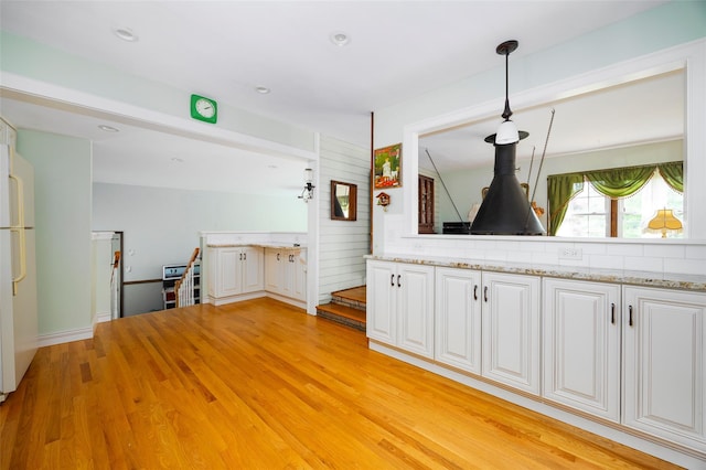 68 Forest Dr, Poughquag, NY 12570 - kitchen with white cabinets, light wood-style floors, hanging light fixtures, light stone countertops, and recessed lighting