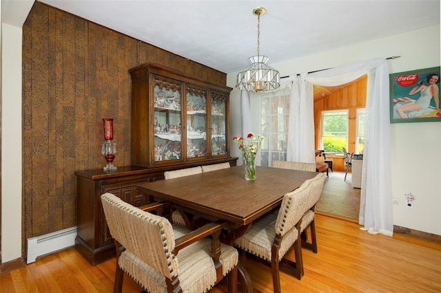 68 Forest Dr, Poughquag, NY 12570 - dining room with a baseboard radiator, a chandelier, light wood-style floors, baseboards, and wood walls