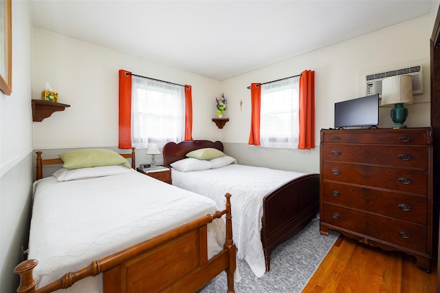 68 Forest Dr, Poughquag, NY 12570 - bedroom featuring wood finished floors, multiple windows, and a wall mounted air conditioner