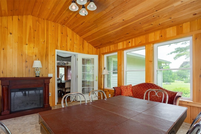 68 Forest Dr, Poughquag, NY 12570 - dining room featuring vaulted ceiling, wood walls, wood ceiling, and a glass covered fireplace
