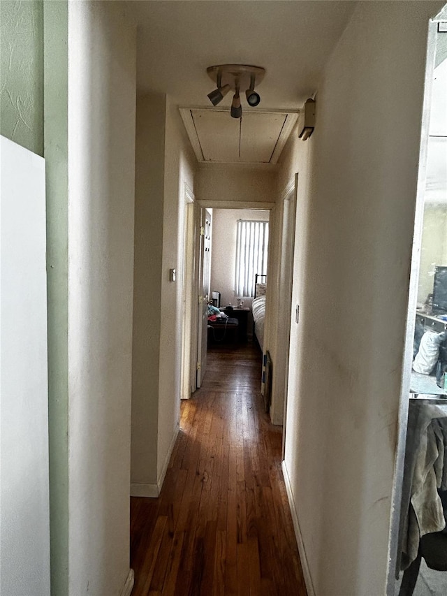 275 Beachview St, Copiague, NY 11726 - corridor with attic access, wood-type flooring, and baseboards