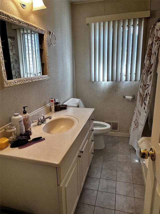 275 Beachview St, Copiague, NY 11726 - full bath with toilet, vanity, tile patterned flooring, and a textured wall