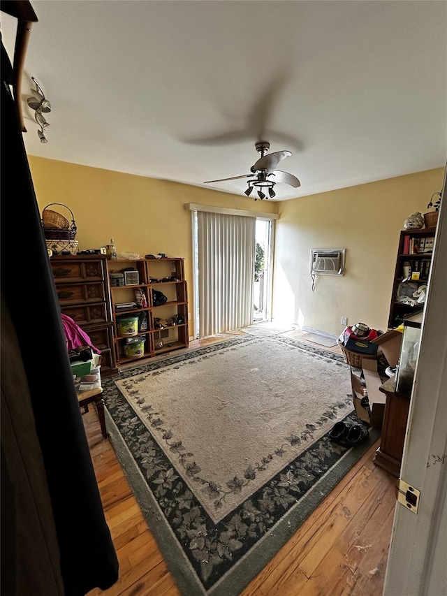 275 Beachview St, Copiague, NY 11726 - living area with wood-type flooring, a ceiling fan, and a wall unit AC