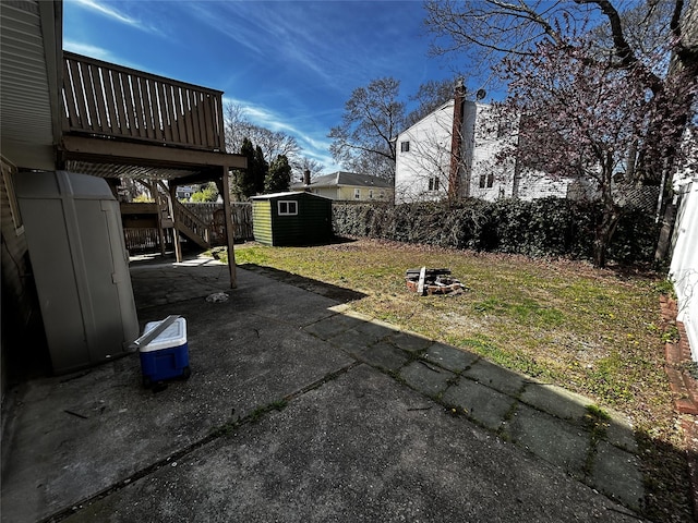 275 Beachview St, Copiague, NY 11726 - view of patio with a storage unit, an outbuilding, stairway, a fenced backyard, and a fire pit