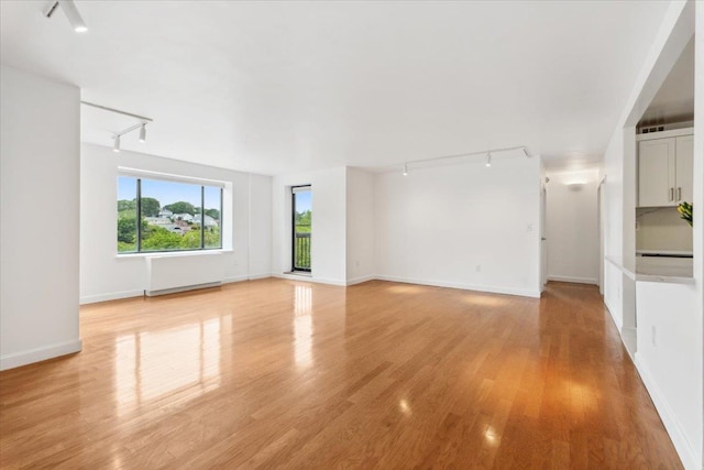 50 Columbus Ave Unit 605, Tuckahoe, NY 10707 - unfurnished living room featuring rail lighting, light wood finished floors, and baseboards