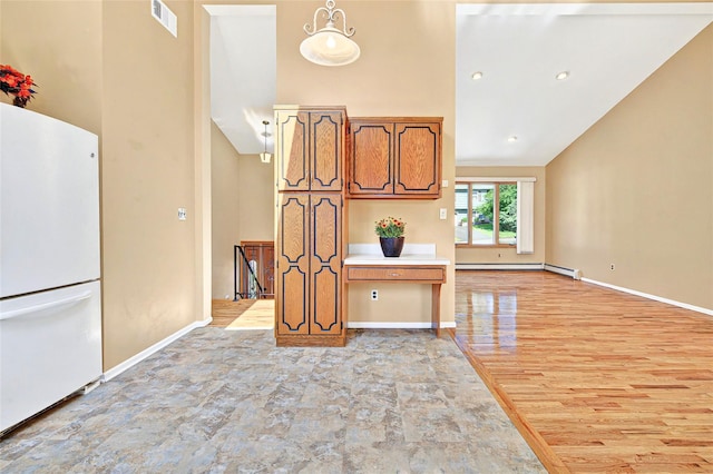 8 Skinner Ct, Tomkins Cove, NY 10986 - kitchen featuring freestanding refrigerator, a baseboard heating unit, high vaulted ceiling, brown cabinets, and baseboards