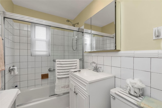 204-08 35th Ave Unit 247, Bayside, NY 11361 - bathroom featuring tile walls, toilet, combined bath / shower with glass door, vanity, and decorative backsplash