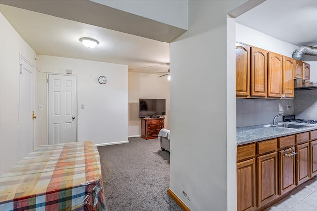 144-44 38th Ave Unit 6G, Flushing, NY 11354 - kitchen with a sink, backsplash, light carpet, ceiling fan, and brown cabinetry