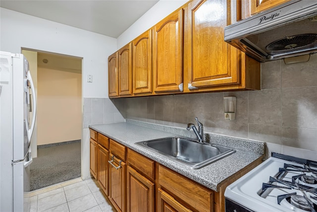 144-44 38th Ave Unit 6G, Flushing, NY 11354 - kitchen with white appliances, under cabinet range hood, a sink, brown cabinetry, and tasteful backsplash