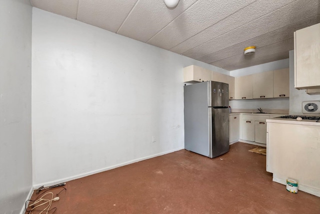 154-04 107th Ave, Jamaica, NY 11433 - kitchen with freestanding refrigerator, light countertops, finished concrete flooring, a sink, and baseboards