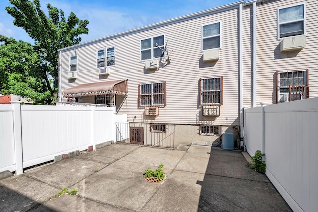 154-04 107th Ave, Jamaica, NY 11433 - back of house featuring a patio, fence, central AC, and cooling unit